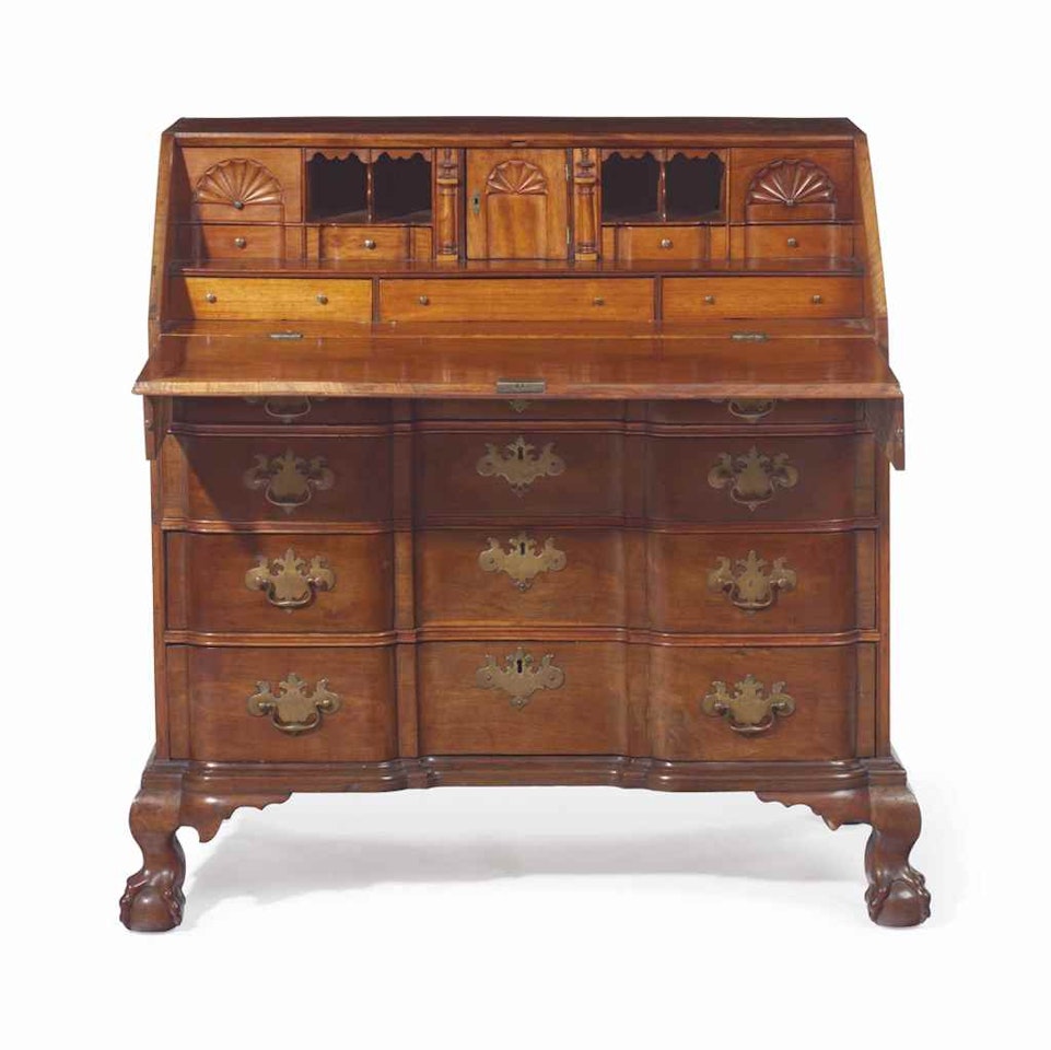 A CHIPPENDALE CARVED MAHOGANY BLOCK-FRONT SLANT-FRONT DESK by Anonymous