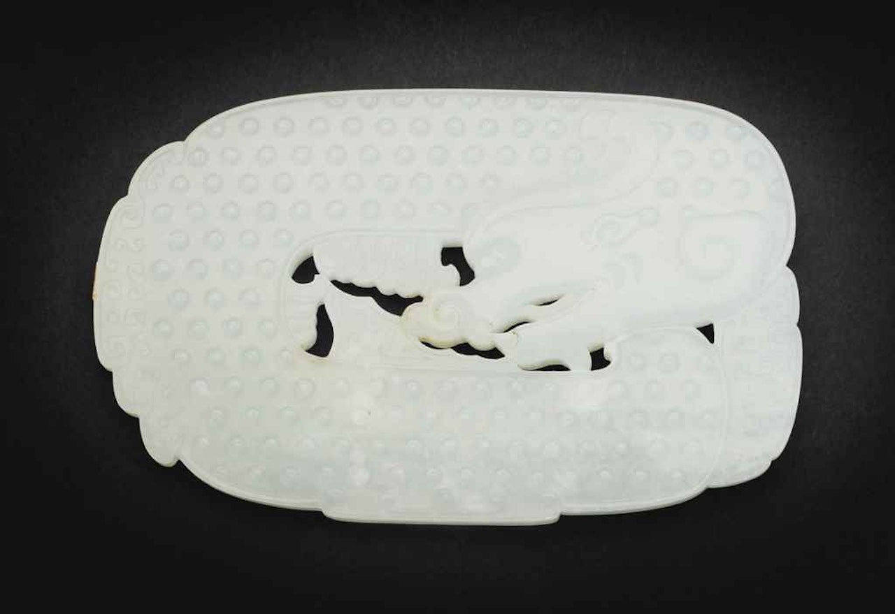 A FINELY CARVED WHITE JADE ARCHAISTIC 'DRAGON-CARP' PLAQUE by Anonymous