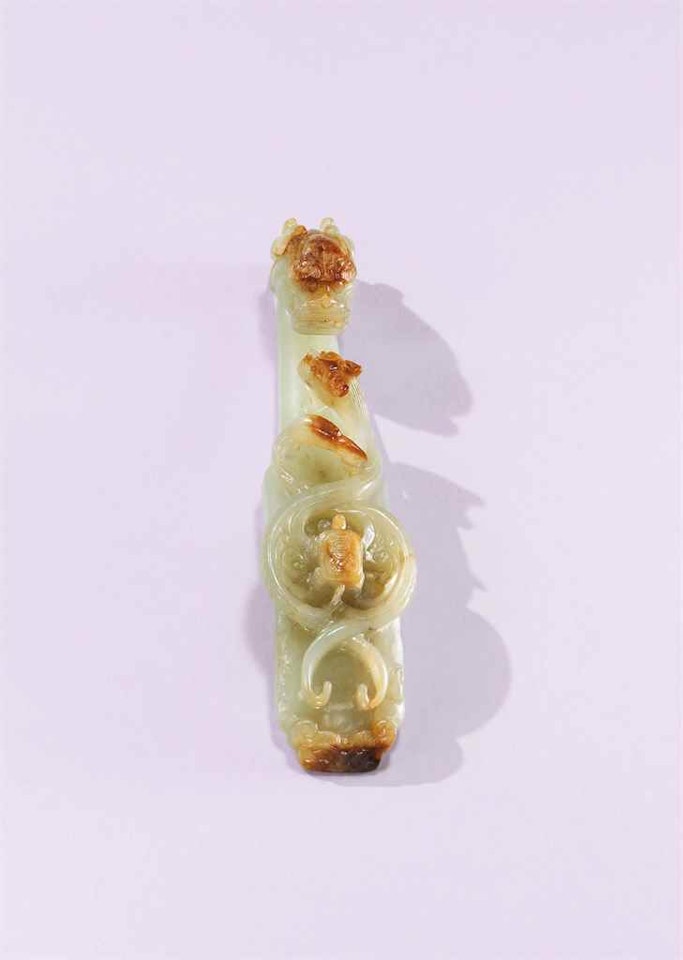 A PALE CELADON JADE ‘GUARDIANS OF THE FOUR DIRECTIONS’ BELT HOOK by Anonymous