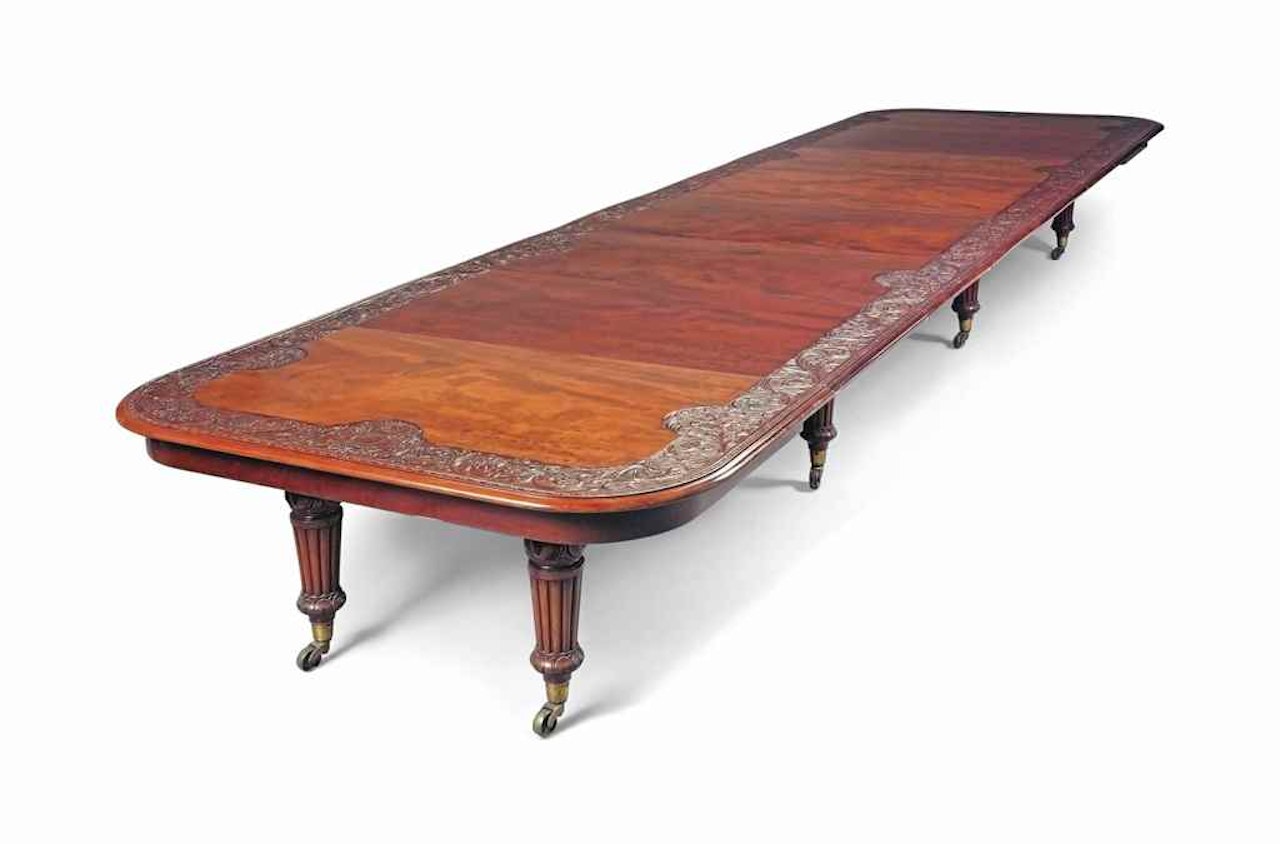 AN EARLY VICTORIAN MAHOGANY EXTENDING DINING TABLE by Anonymous