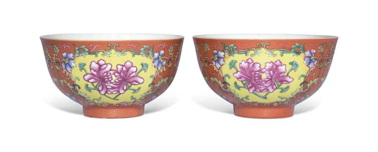 A PAIR OF CORAL-GROUND FAMILLE ROSE BOWLS by Anonymous