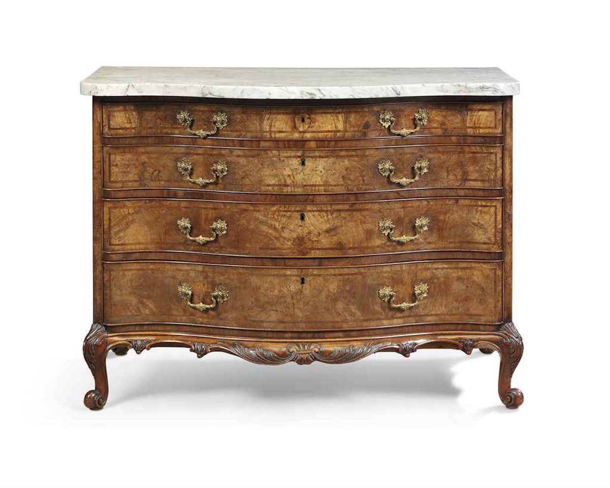 A GEORGE II WALNUT SERPENTINE COMMODE by Anonymous