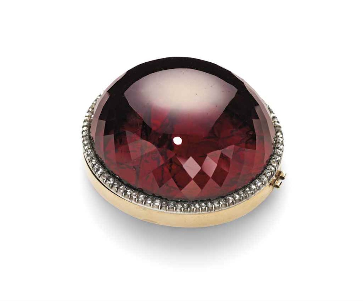 A JEWELLED SILVER AND TWO-COLOUR GOLD-MOUNTED GARNET LOCKET by Anonymous