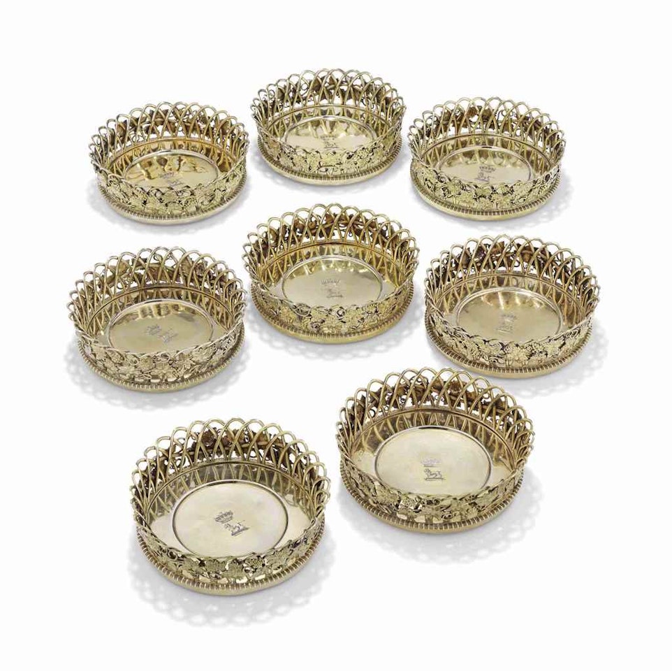 A SET OF EIGHT GEORGE III SILVER-GILT WINE-COASTERS by Anonymous