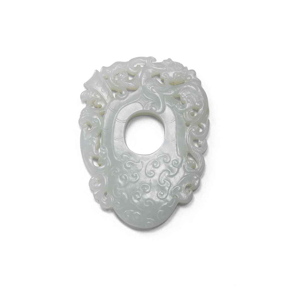 A RETICULATED WHITE JADE PLECTRUM-SHAPED PLAQUE by Anonymous