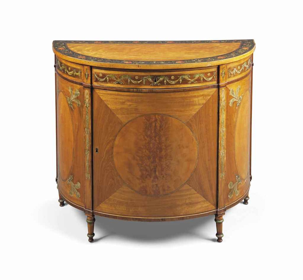 A GEORGE III SATINWOOD AND POLYCHROME-DECORATED DEMI-LUNE COMMODE by Anonymous
