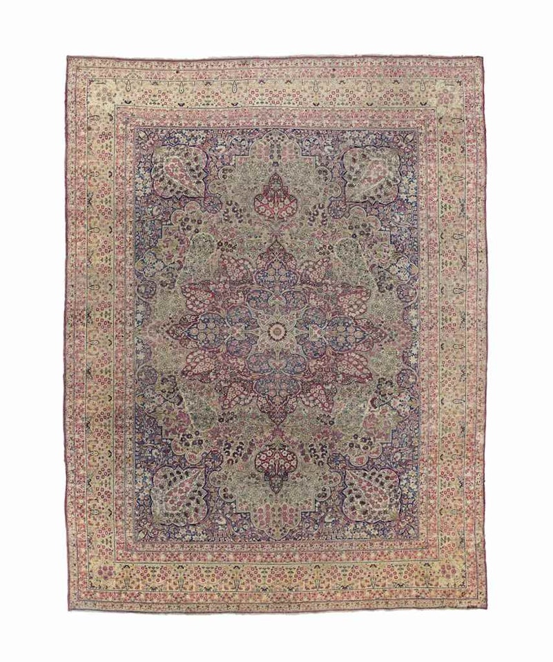 A KIRMAN LAVER CARPET by Anonymous