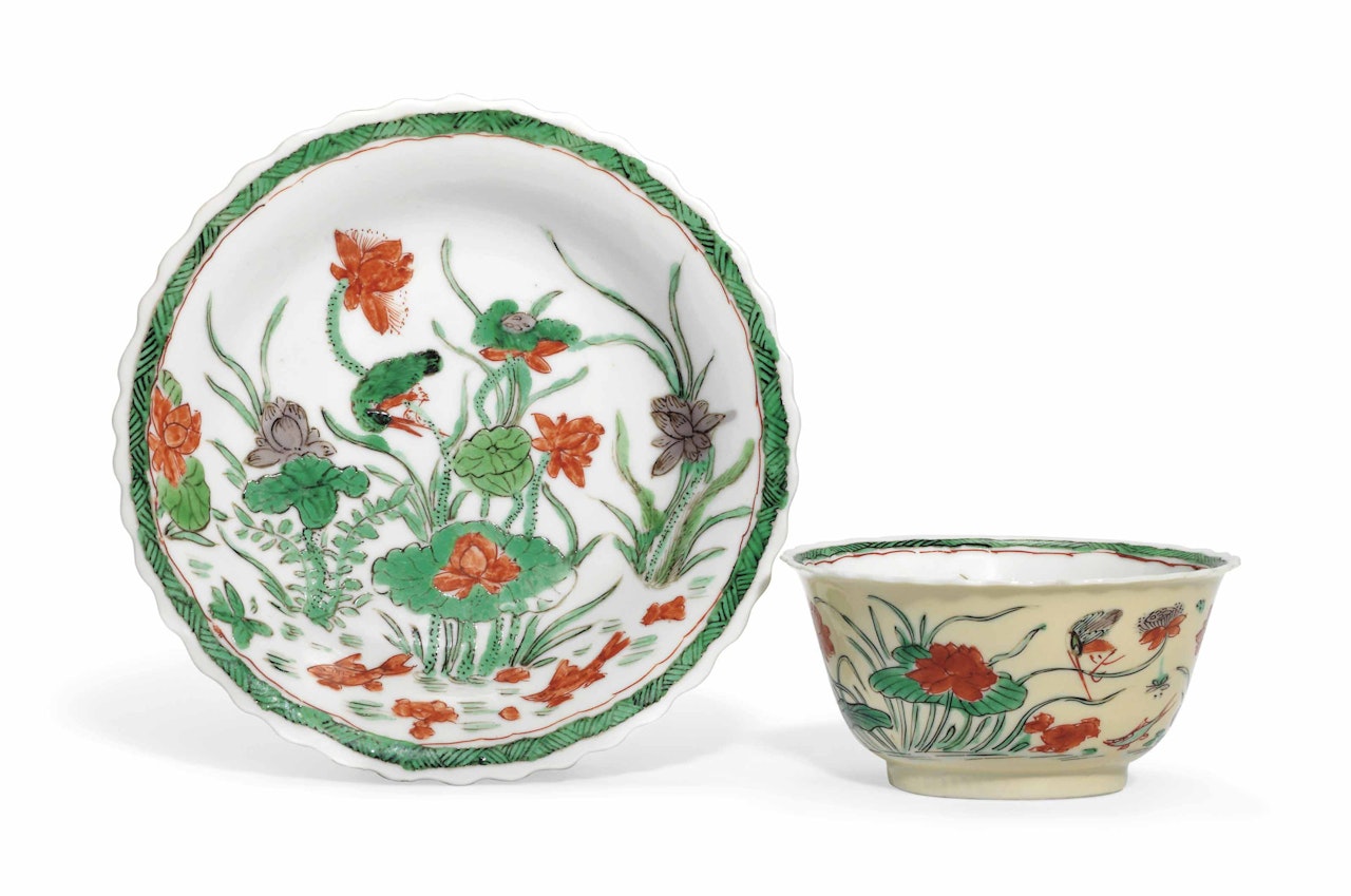 A CAFÉ-AU-LAIT-GROUND FAMILLE VERTE 'LOTUS POND' CUP AND SAUCER by Anonymous