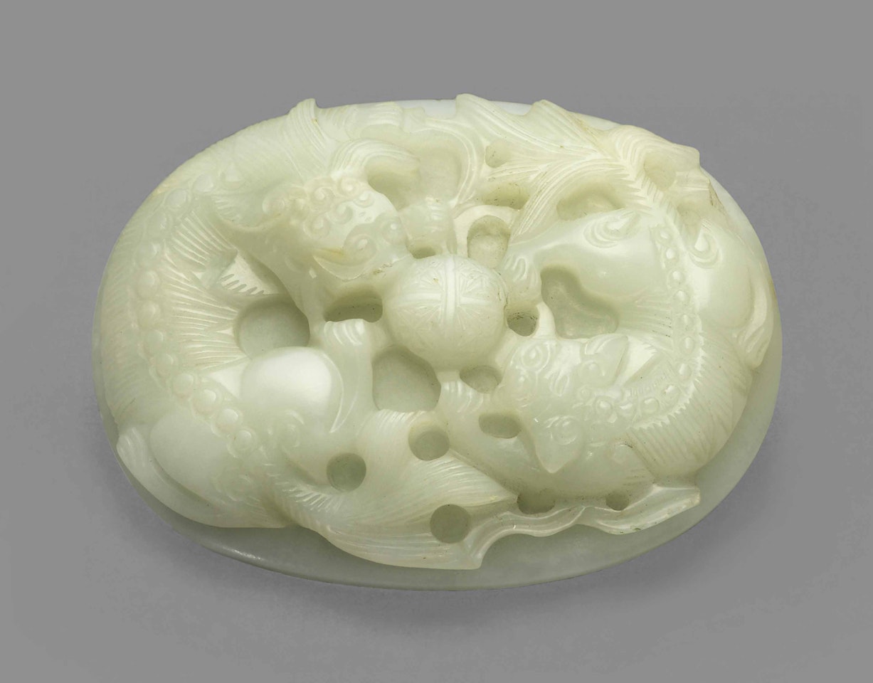 A WHITE JADE 'BUDDHIST LION' BELT BUCKLE by Anonymous