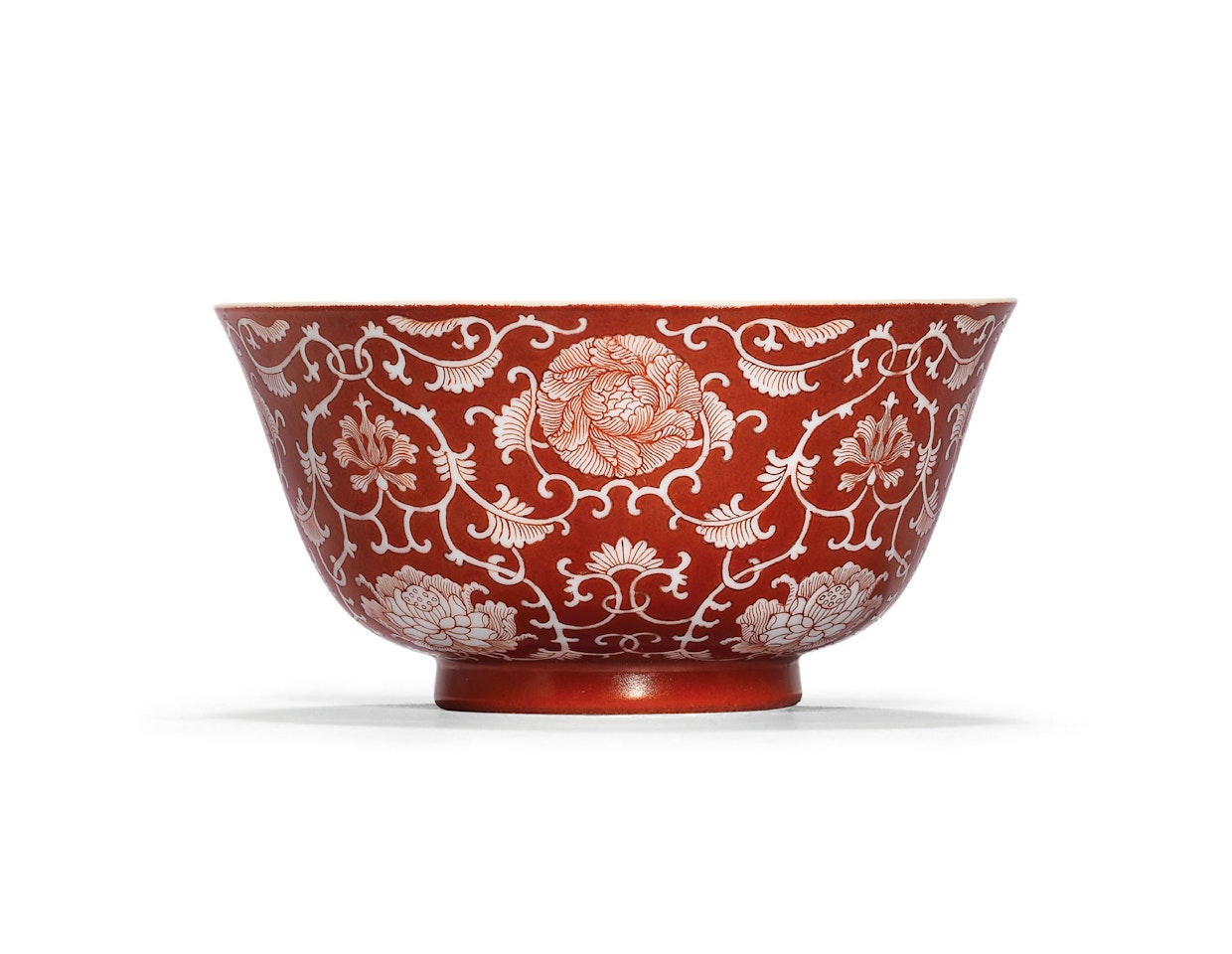 A CORAL-GROUND RESERVE-DECORATED ‘LOTUS’ BOWL by Anonymous