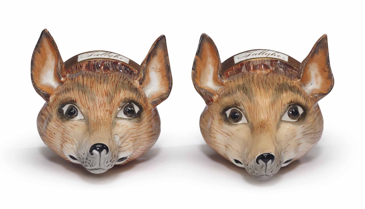 A PAIR OF ENGLISH PORCELAIN STIRRUP-CUPS MODELED AS FOX HEADS by Anonymous