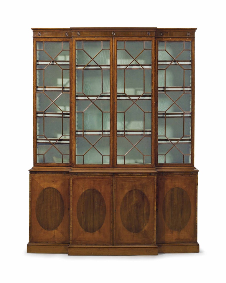 A GEORGE III SATINWOOD, PADOUK AND TULIPWOOD BREAKFRONT BOOKCASE by Anonymous