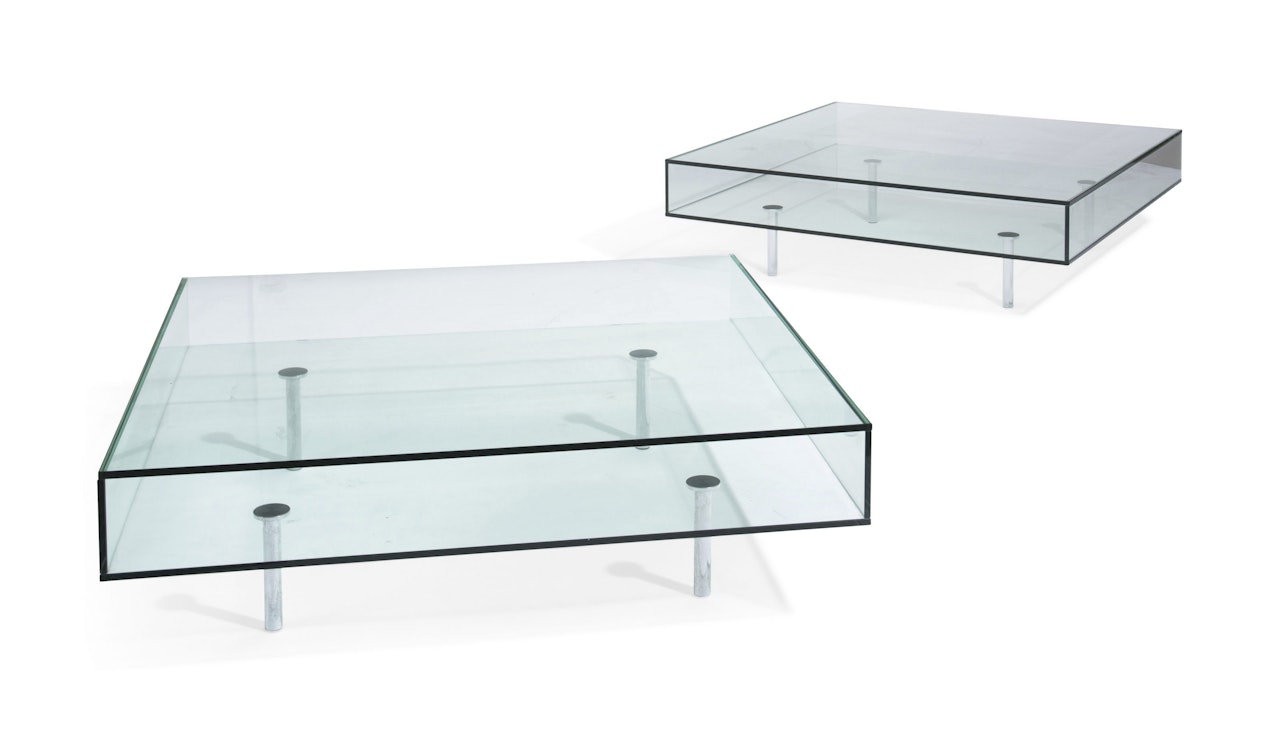 A PAIR OF CHROME AND GLASS POCKET-FORM LOW TABLES by Anonymous