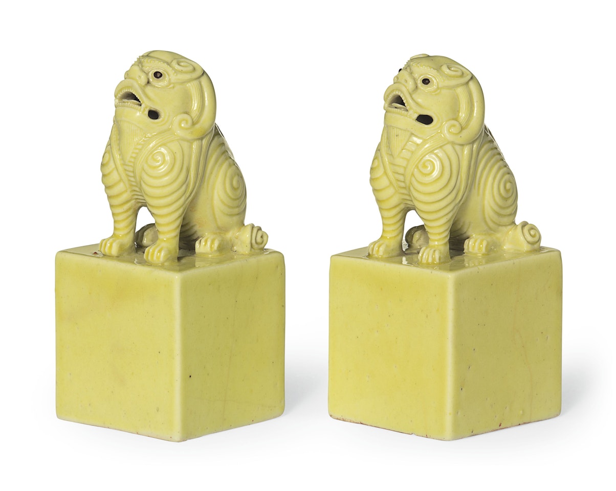 A PAIR OF YELLOW-GLAZED PORCELAIN SEALS by Anonymous