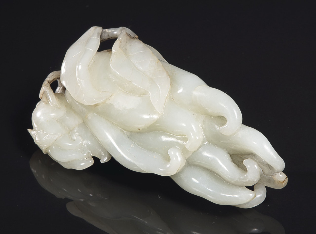 A WHITE AND DARK BROWN JADE 'BUDDHA'S HAND' CITRON by Anonymous