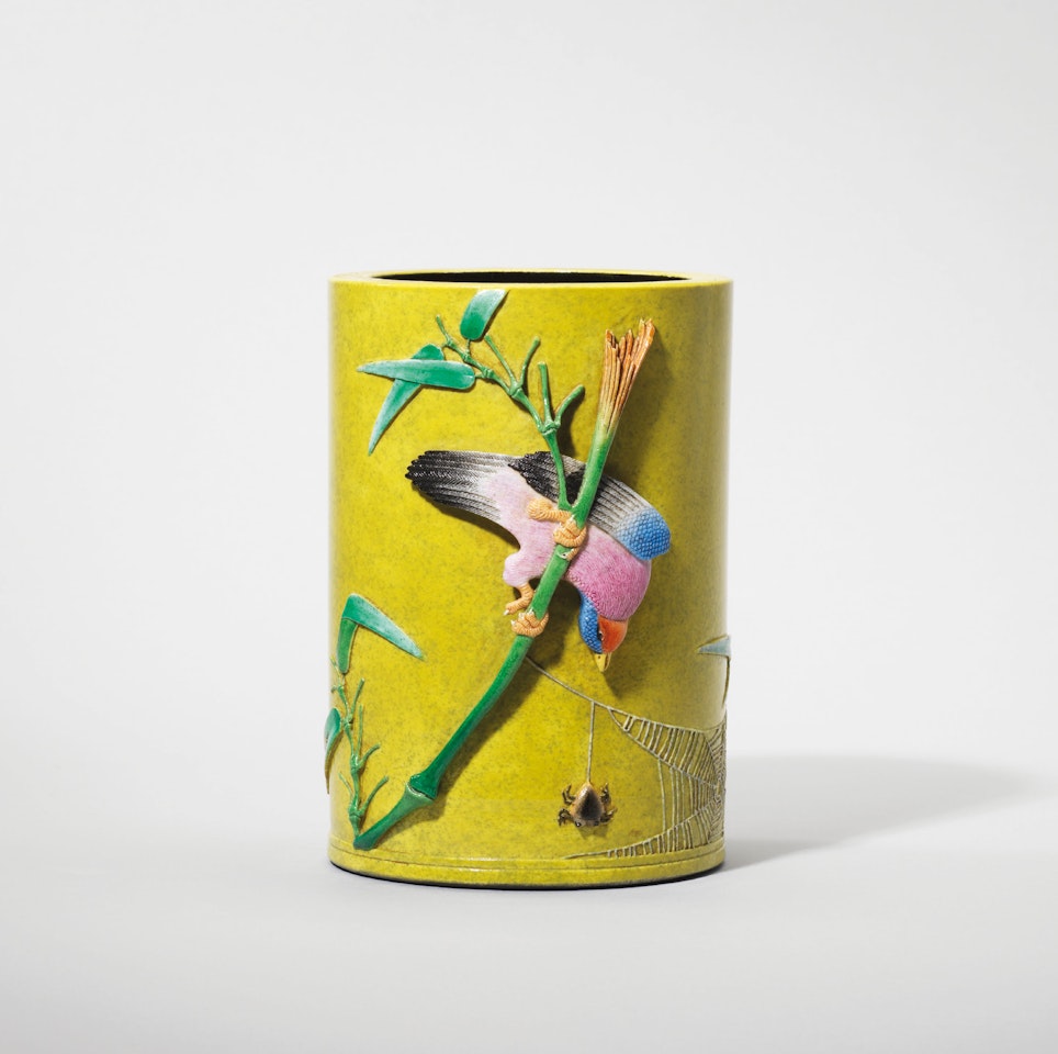 A CARVED YELLOW-GROUND FAMILLE ROSE ‘BIRD AND FLOWER’ BRUSH POT, BITONG by Anonymous