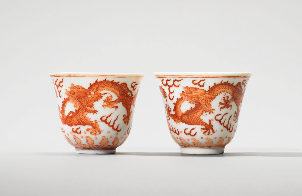 TWO IRON-RED DECORATED ‘DRAGON’ WINE CUPS by Anonymous