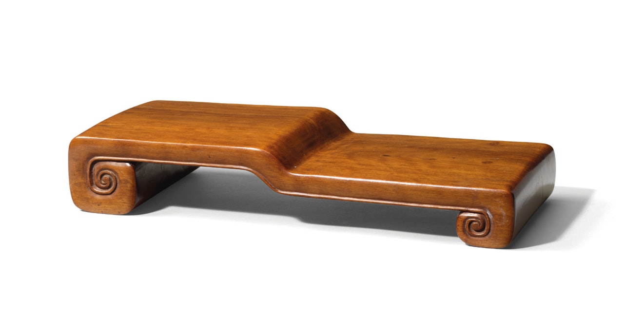 A HARDWOOD SCROLL-FORM STEPPED STAND by Anonymous