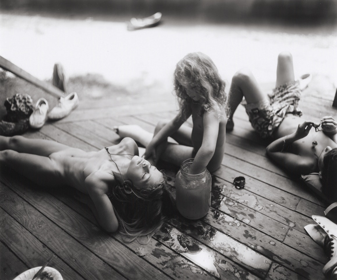 Listening to Madonna by the Tadpole Jar by Sally Mann