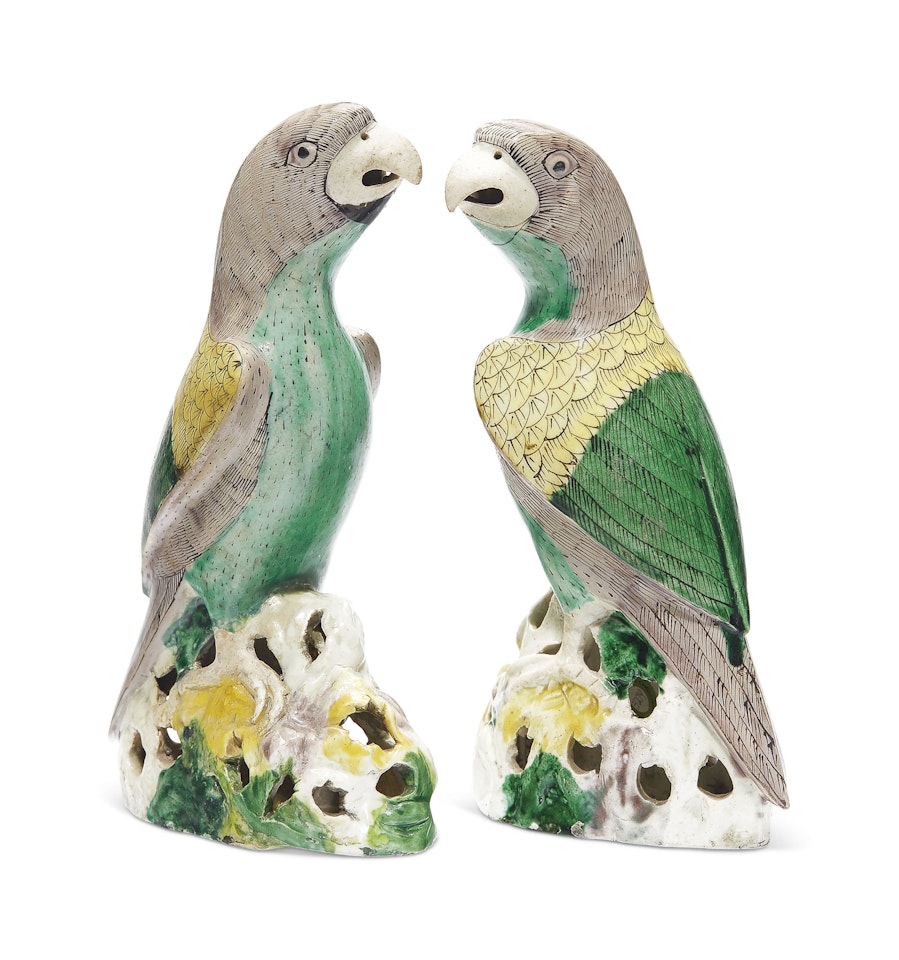 A PAIR OF BISCUIT-GLAZED PARROTS by Anonymous