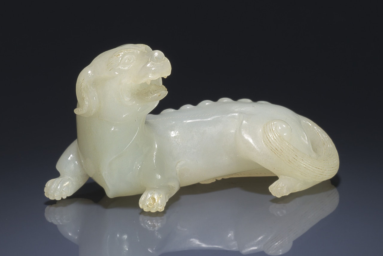 A WHITE JADE CARVING OF A HOUND by Anonymous