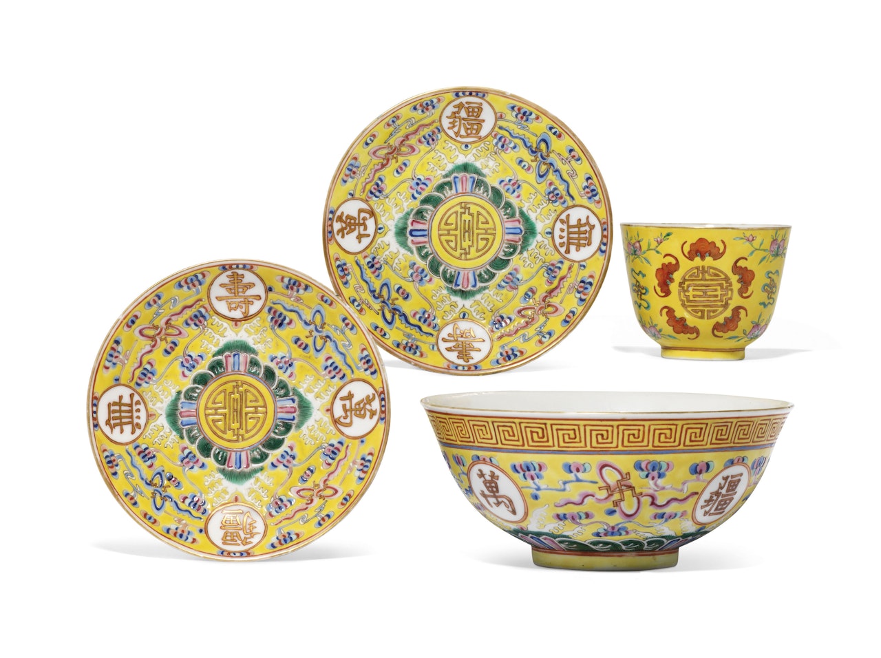 FOUR FAMILLE ROSE YELLOW-GROUND 'BIRTHDAY' VESSELS by Anonymous