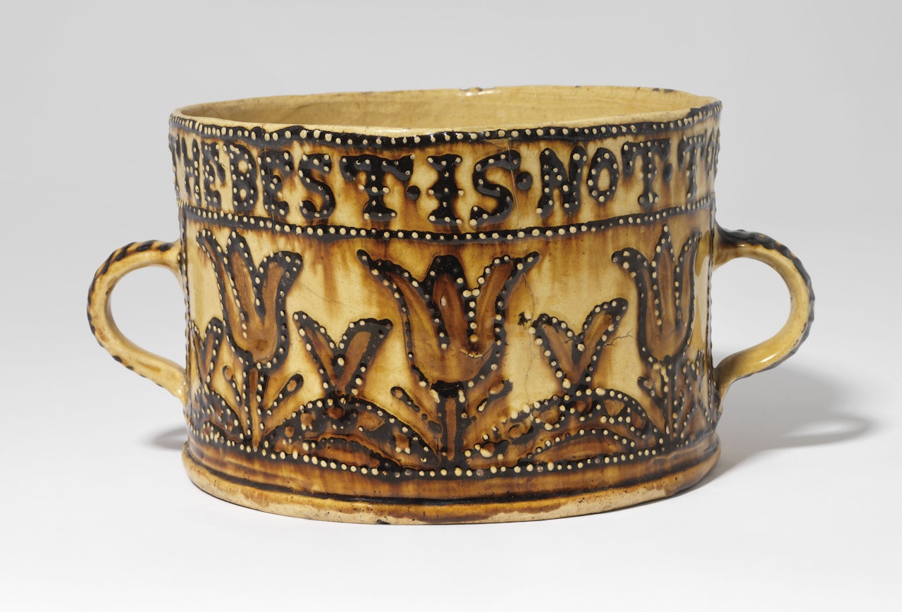 A STAFFORDSHIRE SLIPWARE TWO-HANDLED BRAGGET-POT by Anonymous