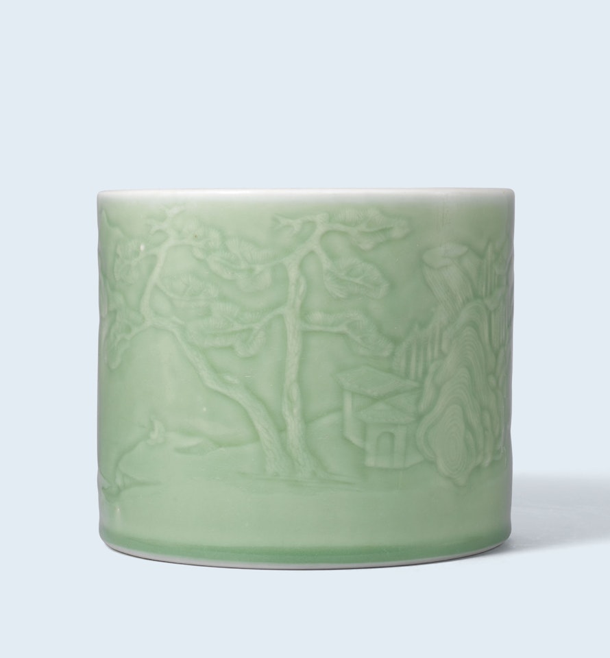 A RARE CARVED 'LANDSCAPE' CELADON-GLAZED BRUSH POT by Anonymous