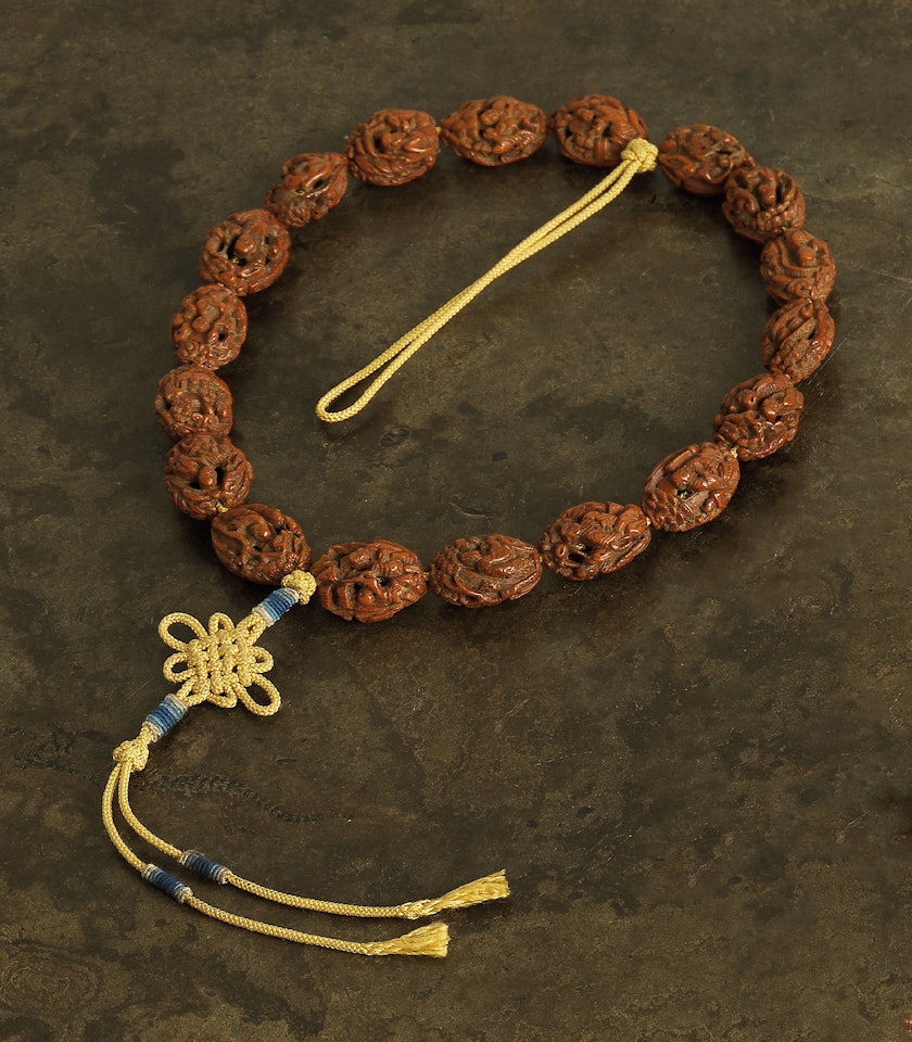 A STRING OF CARVED FRUIT NUT ‘LUOHAN’ ROSARY BEADS, SHOUCHUAN by Anonymous