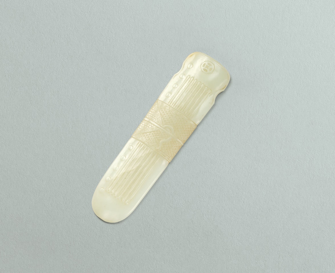 A CARVED WHITE JADE QIN by Anonymous