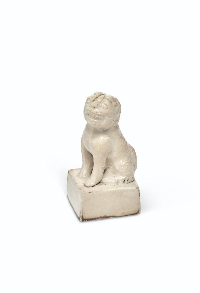 A WHITE-GLAZED 'LION' SEAL by Anonymous