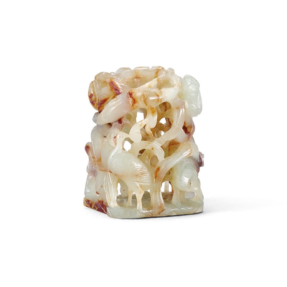 A PALE CELADON AND RUSSET JADE RETICULATED ‘CRANE AND LOTUS’ FINIAL by Anonymous