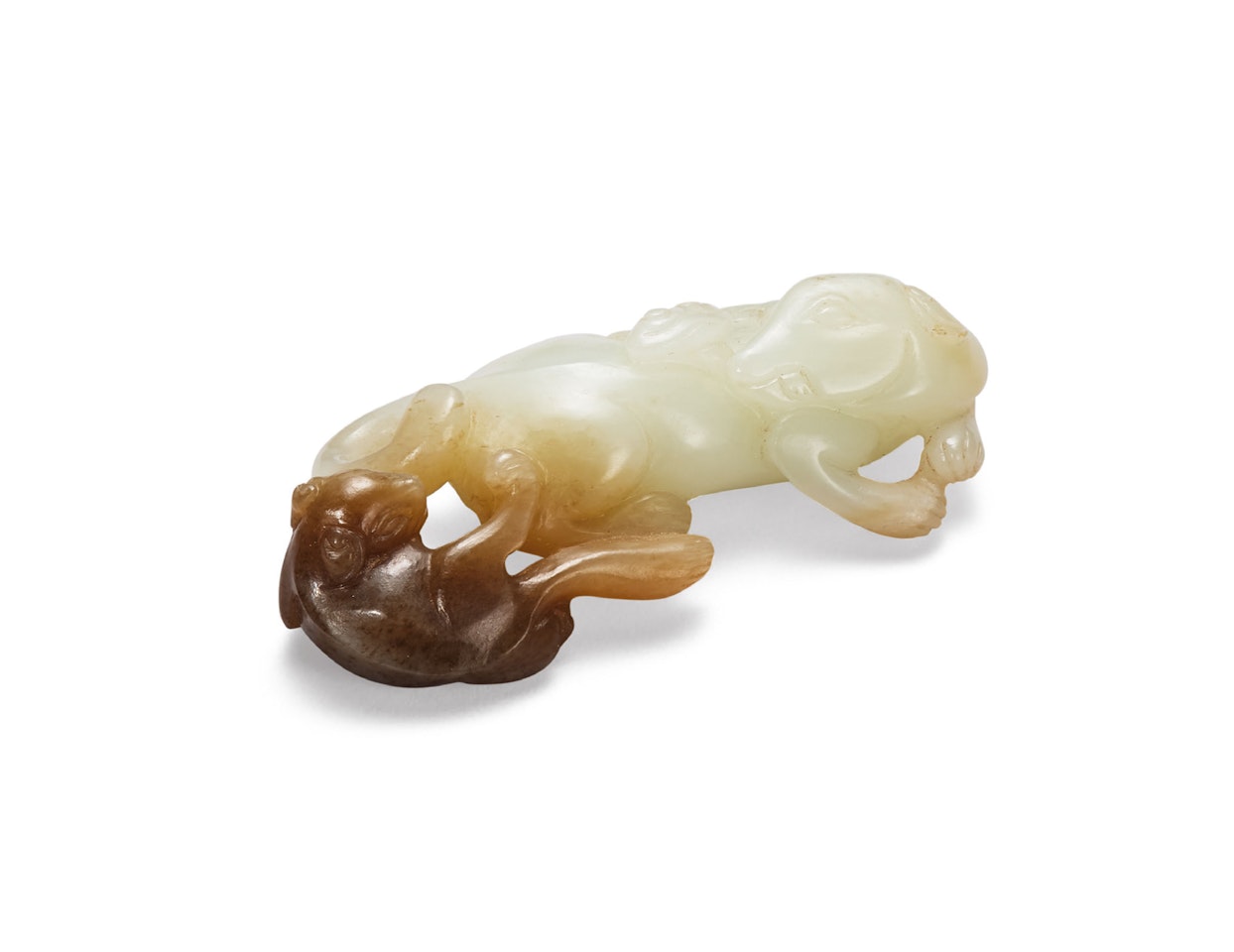 A WHITE AND RUSSET JADE CARVING OF A RECUMBENT DOG AND ITS PUPPY by Anonymous