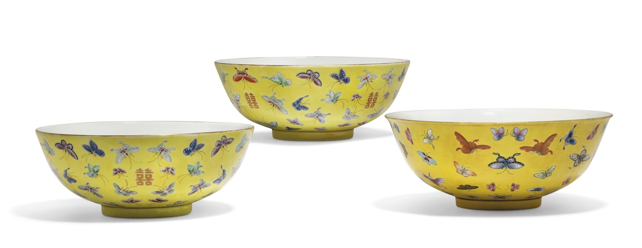 A PAIR OF FAMILLE ROSE YELLOW-GROUND 'BUTTERFLY AND XI' LARGE BOWLS AND A 'BUTTERFLY' BOWL by Anonymous