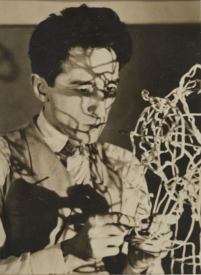 Jean Cocteau et son autoportrait en fil de fer by Man Ray