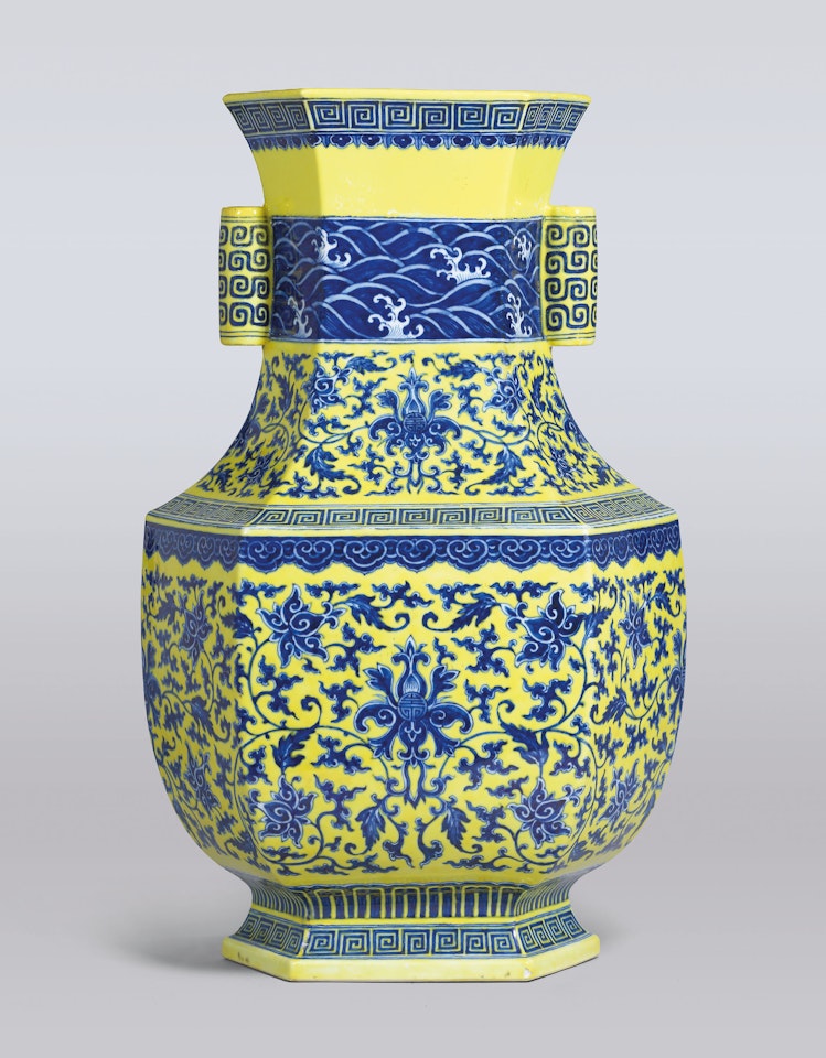 A VERY RARE YELLOW-GROUND UNDERGLAZE-BLUE DECORATED ‘LOTUS SCROLL’ HEXAGONAL VASE by Anonymous