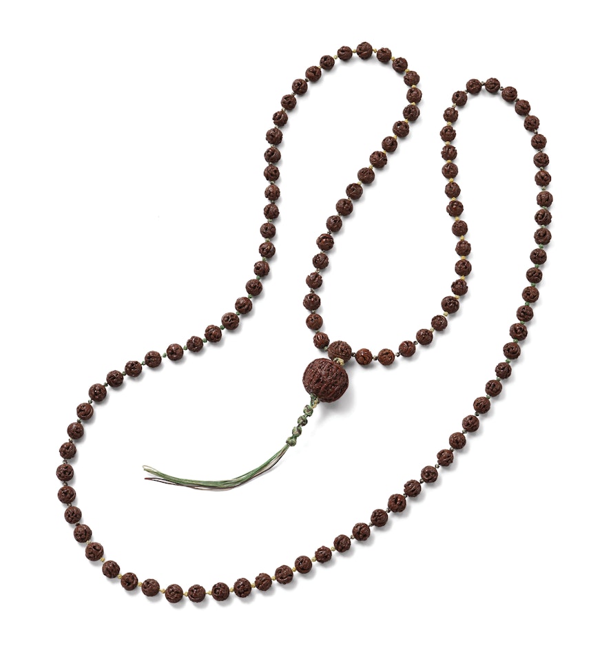 A CARVED NUT NECKLACE by Anonymous