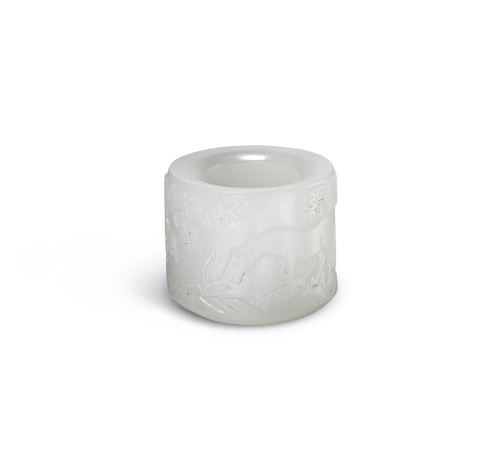 AN INSCRIBED WHITE JADE ‘HORSE’ ARCHER’S RING by Anonymous