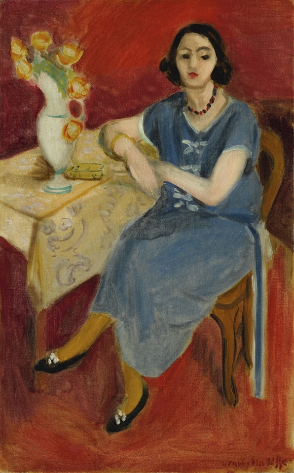 FEMME EN BLEU À TABLE, FOND ROUGE by Henri Matisse