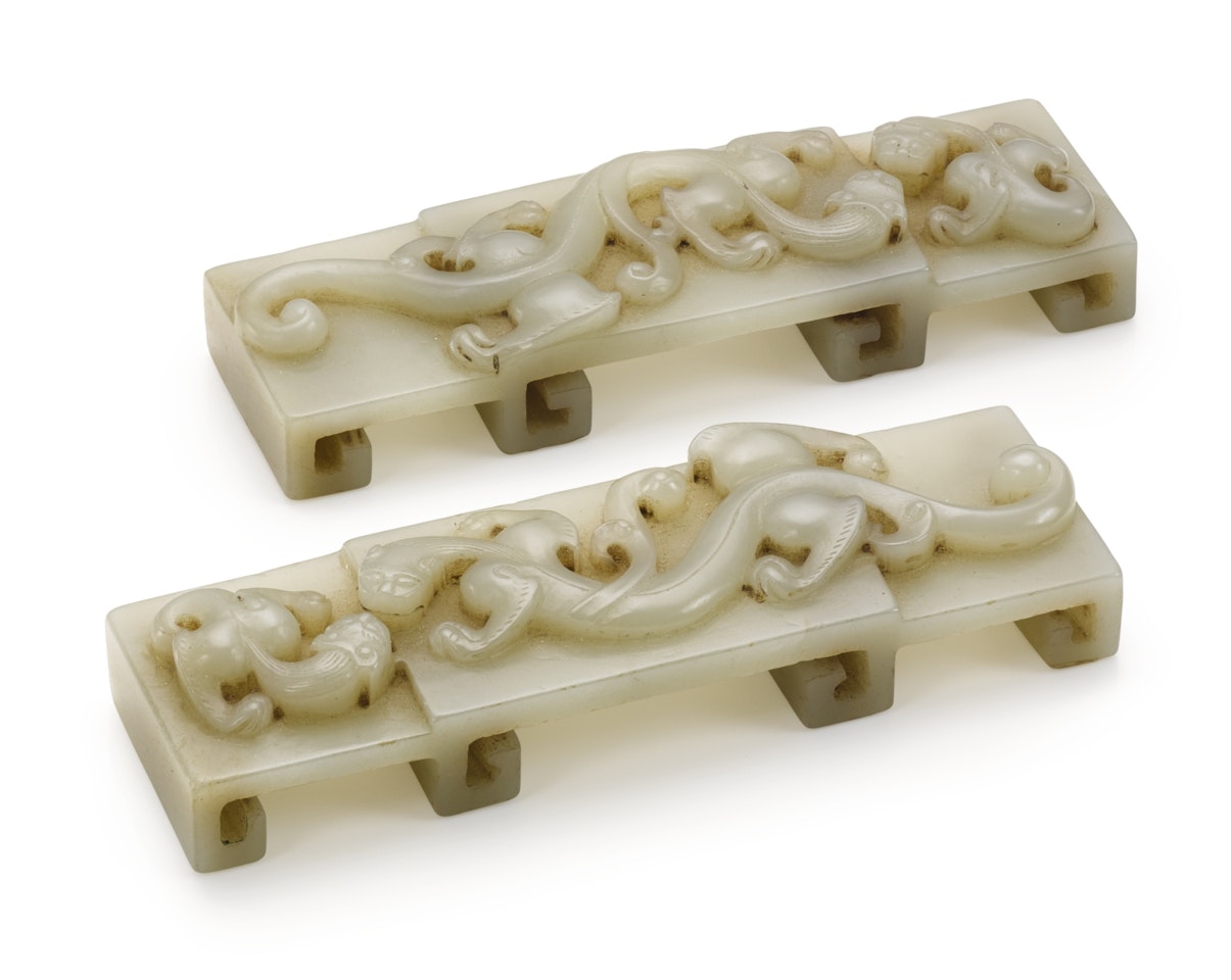 A PAIR OF PALE CELADON JADE ARCHAISTIC ‘CHILONG’ PAPERWEIGHTS by Anonymous