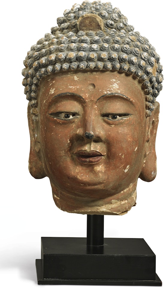 A LARGE STUCCO HEAD OF A BUDDHA by Anonymous