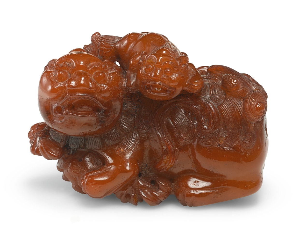 AN AMBER 'LION' GROUP by Anonymous