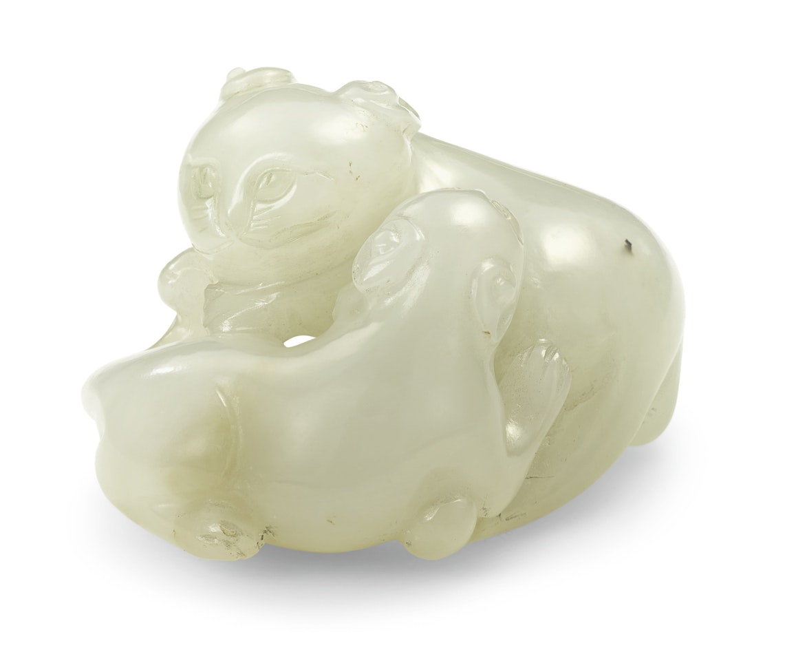 A WHITE JADE CARVING OF TWO CATS by Anonymous