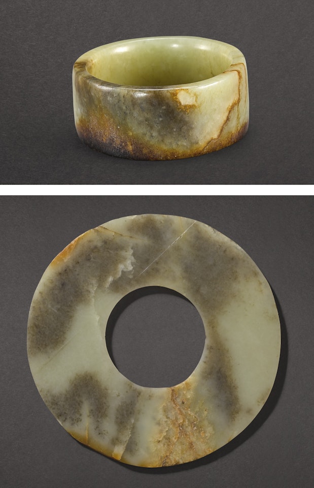 A CELADON AND BROWN JADE CYLINDER OR BRACELET AND A JADE DISC, HUAN by Anonymous