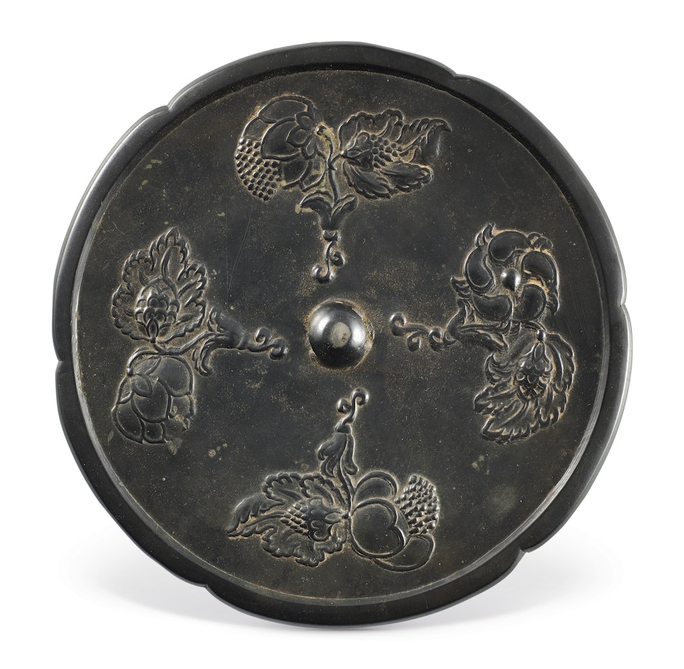 A BRONZE HEXAFOIL 'FLORAL' MIRROR by Anonymous