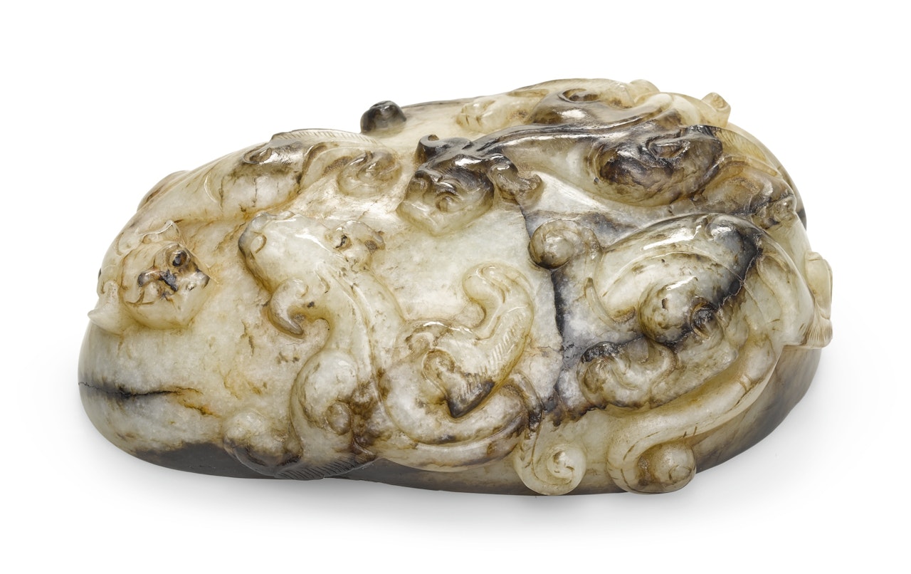 A PALE CELADON, RUSSET AND BLACK JADE 'CHILONG' SCROLL WEIGHT by Anonymous