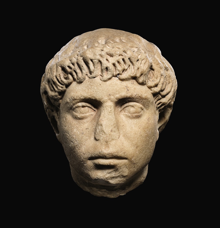 A ROMAN MARBLE PORTRAIT HEAD OF A YOUNG MAN, HADRIANIC by Anonymous