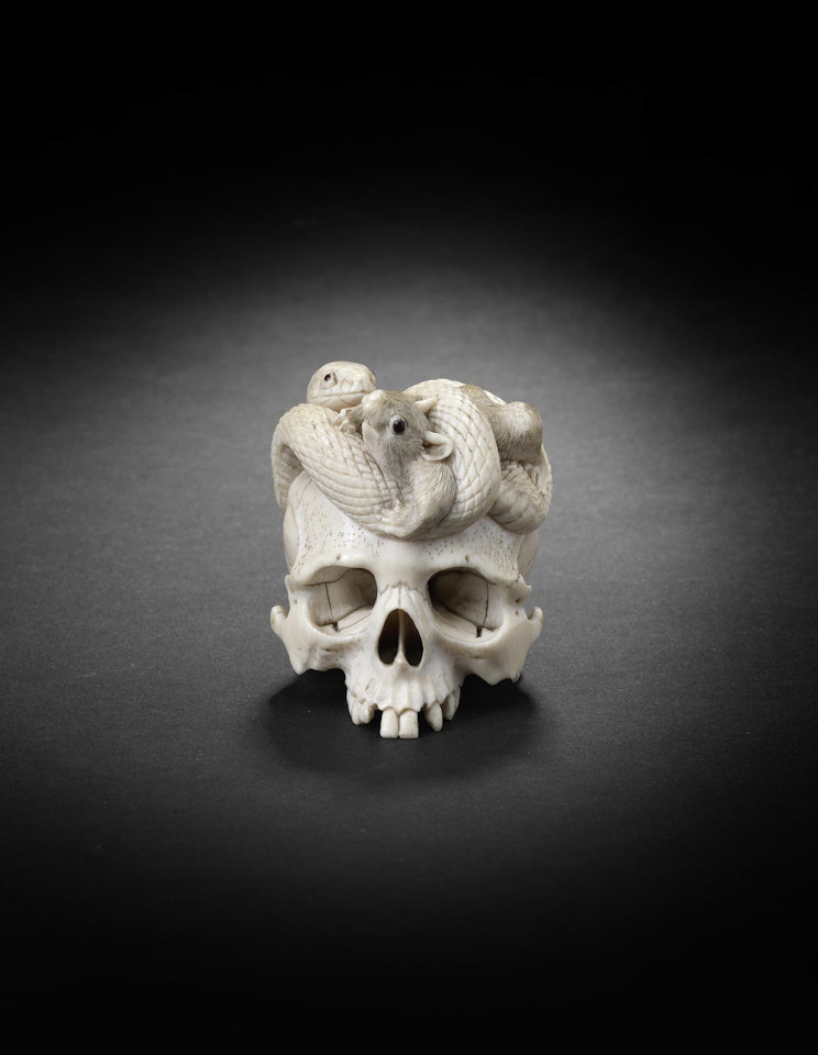 An ivory okimono group of a snake and rat on a human skull by Anonymous