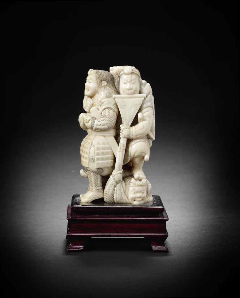 A Walrus tusk okimono figure group by Anonymous