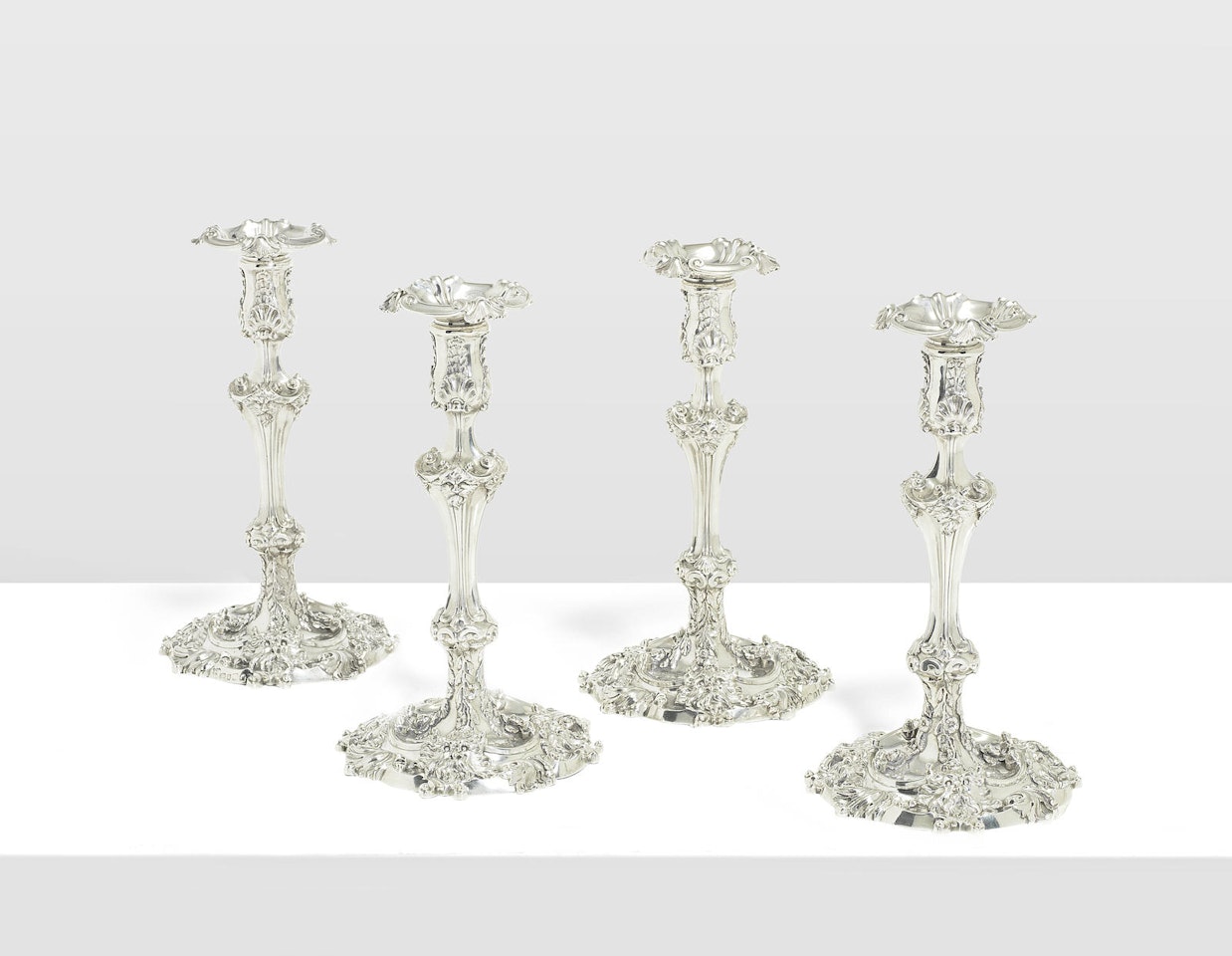 A fine set of four George III silver candlesticks by Anonymous